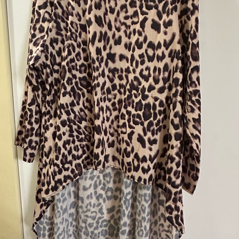 Stylish Leopard Print Long Sleeve Blouse that’s long in the back. Runs small